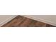 Close up view of hardwood-look flooring with clean trim at 7070 Ravenwood Ln, Lithonia, GA 30038