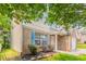 Two-story home with brick facade, blue shutters, and small landscaped yard at 7070 Ravenwood Ln, Lithonia, GA 30038
