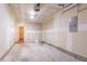 Unfinished two car garage with a side entry door and electrical panel at 7070 Ravenwood Ln, Lithonia, GA 30038