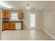 Neutral kitchen with light-wood cabinets, white appliances, and backyard access at 7070 Ravenwood Ln, Lithonia, GA 30038
