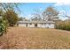 Expansive backyard view showcasing the home's rear facade and a spacious, tree-lined lot with a blank canvas for outdoor enjoyment at 1066 Cleavemark Dr, Clarkston, GA 30021