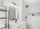 Elegant bathroom featuring stylish lighting, sink, and marble-tiled shower at 1066 Cleavemark Dr, Clarkston, GA 30021