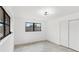 Empty bedroom with a closet, black framed windows, and herringbone flooring at 1066 Cleavemark Dr, Clarkston, GA 30021