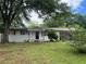 Ranch-style home featuring a white brick exterior, covered entrance, and lush greenery at 1066 Cleavemark Dr, Clarkston, GA 30021