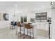 Bright kitchen with white cabinetry, an island with seating, and modern appliances at 1066 Cleavemark Dr, Clarkston, GA 30021