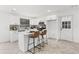 Well-lit kitchen featuring a kitchen island with seating and white cabinetry at 1066 Cleavemark Dr, Clarkston, GA 30021