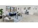 Bright living room with a blue velvet sofa, accent chairs, and large picture window at 1066 Cleavemark Dr, Clarkston, GA 30021