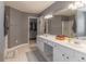 Elegant bathroom with double vanity, a walk-in closet, and a separate shower at 939 Bendleton Dr, Woodstock, GA 30188