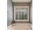 Relaxing bathroom featuring a soaking tub with a large window overlooking the garden at 939 Bendleton Dr, Woodstock, GA 30188