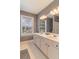 Bright bathroom with a double vanity and a window providing natural light at 939 Bendleton Dr, Woodstock, GA 30188