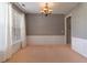 Inviting dining room featuring classic wainscoting, neutral walls, and a decorative light fixture at 939 Bendleton Dr, Woodstock, GA 30188