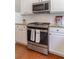 Modern stainless steel oven and microwave complementing the white cabinetry and granite countertops at 939 Bendleton Dr, Woodstock, GA 30188