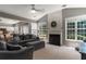 Cozy living room with vaulted ceilings, a fireplace, and views into the kitchen at 939 Bendleton Dr, Woodstock, GA 30188