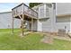 The backyard is an outdoor living space with an elevated wooden deck and a stone-paved area at 946 Redan Trce, Stone Mountain, GA 30088