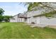 Home backyard with lawn, elevated wooden deck, concrete patio, and exterior doors at 946 Redan Trce, Stone Mountain, GA 30088