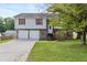 Charming two-story home with a two-car garage and stone accents and front lawn at 946 Redan Trce, Stone Mountain, GA 30088