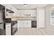 Kitchen featuring white cabinets, modern appliances, and durable floors at 946 Redan Trce, Stone Mountain, GA 30088