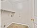 A neutral laundry room featuring shelving and tile flooring at 946 Redan Trce, Stone Mountain, GA 30088