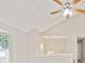 Living area with vaulted ceiling, a ceiling fan, and a charming chandelier at 946 Redan Trce, Stone Mountain, GA 30088