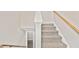Carpeted staircase leading to the upper level with a wooden railing at 946 Redan Trce, Stone Mountain, GA 30088