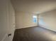 Bedroom featuring plush carpeting, neutral walls, and a window providing natural light at 11045 Shadow Creek Ter, Hampton, GA 30228