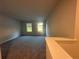 Spacious bonus room featuring neutral walls, plush carpeting, and two bright windows at 11045 Shadow Creek Ter, Hampton, GA 30228