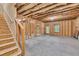 Unfinished basement showing the walls, stairs, window, and door to the outside at 118 Hardy Water Dr, Lawrenceville, GA 30045