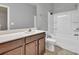 Bathroom with white shower and dark wooden sink and cabinet at 118 Hardy Water Dr, Lawrenceville, GA 30045