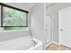 Bathroom features a garden tub, separate shower and window at 118 Hardy Water Dr, Lawrenceville, GA 30045