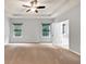 Spacious bedroom features neutral walls, carpet, tray ceiling, and ceiling fan at 118 Hardy Water Dr, Lawrenceville, GA 30045