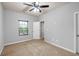 Spacious bedroom with carpet flooring, natural light, and a ceiling fan at 118 Hardy Water Dr, Lawrenceville, GA 30045