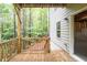 A wooden deck, side of house, and a view of the wooded area at 118 Hardy Water Dr, Lawrenceville, GA 30045