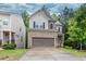 Two-story home with a brick and siding exterior, attached garage, and well-maintained lawn at 118 Hardy Water Dr, Lawrenceville, GA 30045