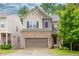 Two-story home with a brick and siding exterior, attached garage, and well-maintained lawn at 118 Hardy Water Dr, Lawrenceville, GA 30045