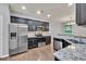 Open kitchen design with stainless steel appliances and granite countertops at 118 Hardy Water Dr, Lawrenceville, GA 30045