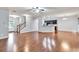 Open concept living room flows into kitchen, featuring hardwood floors and modern lighting at 118 Hardy Water Dr, Lawrenceville, GA 30045