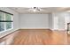 Well-lit living room with hardwood floors, a large window and neutral colored walls at 118 Hardy Water Dr, Lawrenceville, GA 30045