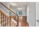 Carpeted staircase with wood railings and metal balusters leading to the upper level at 118 Hardy Water Dr, Lawrenceville, GA 30045