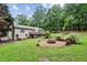 Enjoy this spacious backyard featuring a fire pit and wood deck, perfect for outdoor entertaining and relaxation at 1185 Wedgefield Sw Dr, Marietta, GA 30064
