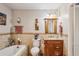 Well-maintained bathroom featuring a tub, vanity, and tiled walls at 1185 Wedgefield Sw Dr, Marietta, GA 30064
