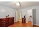 Bedroom with hardwood floors, ceiling fan, and classic dark wood dresser at 1185 Wedgefield Sw Dr, Marietta, GA 30064