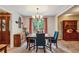 Elegant dining room featuring stylish furniture, a chandelier, carpeted flooring, and a view of the well-maintained backyard at 1185 Wedgefield Sw Dr, Marietta, GA 30064