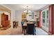 Charming dining room with a wooden table, blue chairs, carpeted flooring, and a view to other rooms and the outdoors at 1185 Wedgefield Sw Dr, Marietta, GA 30064