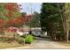 Charming single-story home with a well-manicured lawn, mature trees, and a driveway leading to the front entrance at 1185 Wedgefield Sw Dr, Marietta, GA 30064