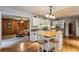 Bright kitchen with white cabinets, breakfast bar, and view into the cozy living room at 1185 Wedgefield Sw Dr, Marietta, GA 30064