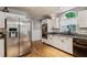 Modern kitchen with stainless steel appliances, white cabinets, and stained-glass window at 1185 Wedgefield Sw Dr, Marietta, GA 30064