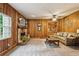Living room with wood paneling, stone fireplace, and a comfortable seating area at 1185 Wedgefield Sw Dr, Marietta, GA 30064