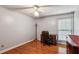 Home office space with a wooden desk, rolling chair, and hardwood floors at 1185 Wedgefield Sw Dr, Marietta, GA 30064