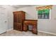 Cozy office space featuring a wooden desk and cabinet with a window view of the outdoors at 1185 Wedgefield Sw Dr, Marietta, GA 30064