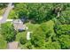 An aerial view showcases the property's layout, including the house, detached garage, expansive yard, and mature trees at 1382 6Th Ave, Auburn, GA 30011